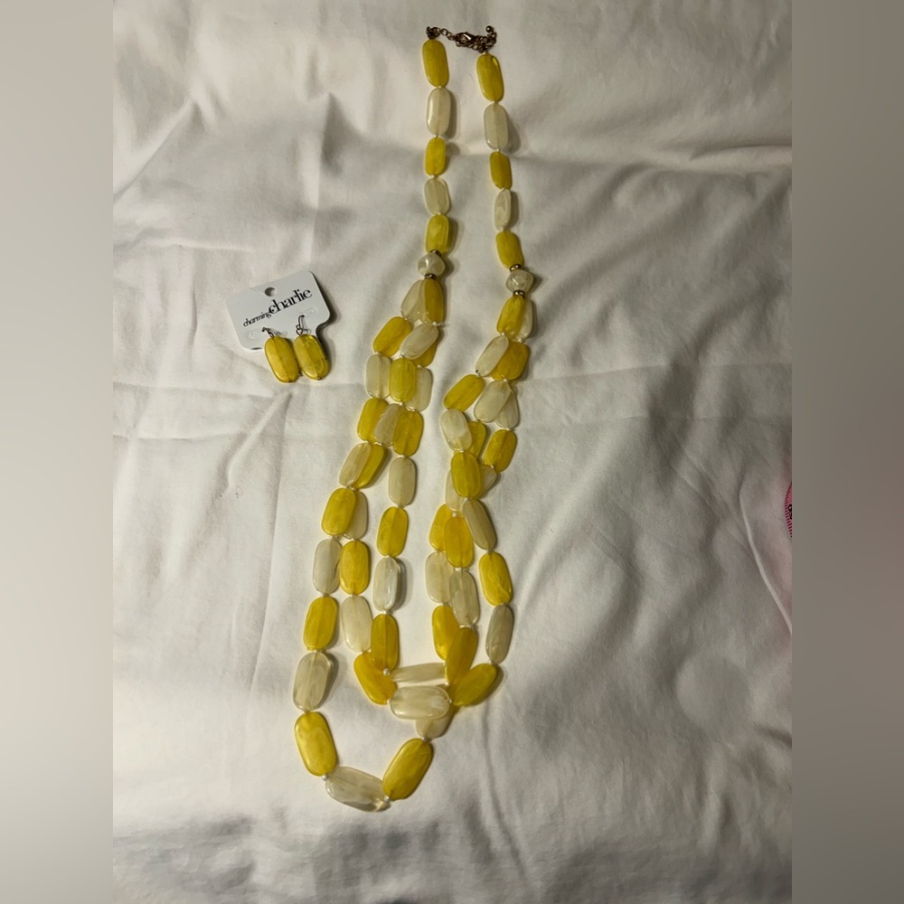 Yellow and ivory colored flat oval beads with Matching earrings included.